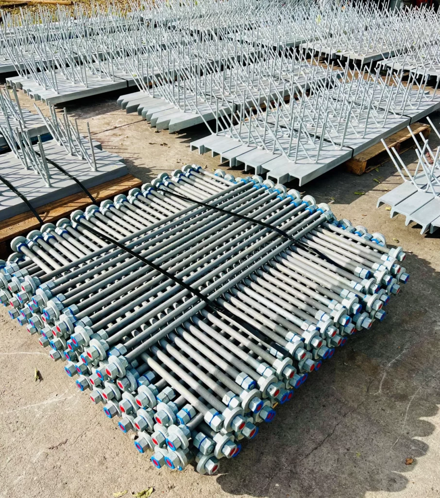 Bundles of galvanized threaded rebar and channel assemblies staged in the Madden Bolt yard.